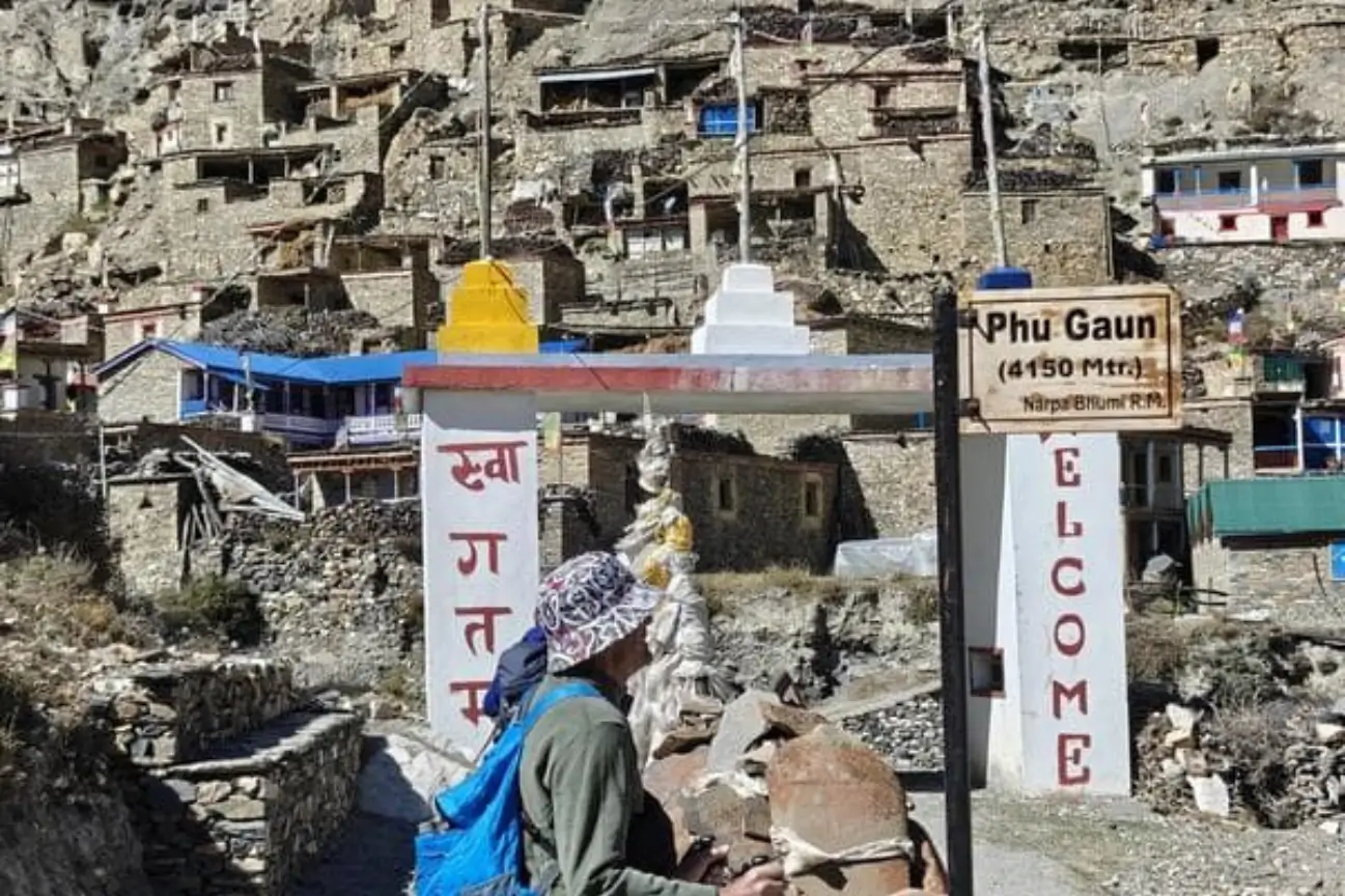 Explore 10N 11D Annapurna Circuit Adventure Hiker entering a high-altitude mountain village during the 10N/11D Annapurna Circuit Adventure.